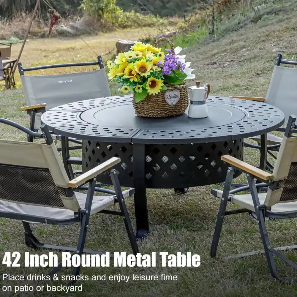 Round metal fire pit with chairs and flowers on a grassy outdoor area